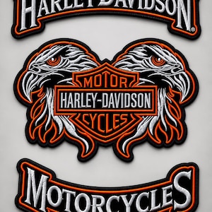 May include: A three-piece embroidered patch set featuring the Harley-Davidson logo in white and orange on a black background. The top and bottom rockers display the text Harley-Davidson and Motorcycles, while the center patch shows two eagle heads.