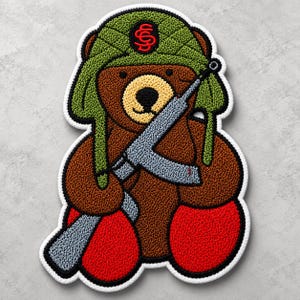 May include: A brown teddy bear patch with a light tan muzzle and black nose. The bear wears a green quilted trapper hat with a red logo on the front and holds a grey rifle across its chest. The bear has bright red feet and a white border.