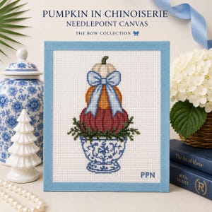 May include: A needlepoint canvas titled PUMPKIN IN CHINOISERIE THE BOW COLLECTION featuring a stack of three pumpkins in white, orange, and red, adorned with a light blue bow, sitting in a blue and white patterned bowl with green foliage.