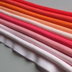 Large passepoil à bride de 7 mm de large sur une bande de 14 mm, couleurs rouges, roses et corail, au mètre