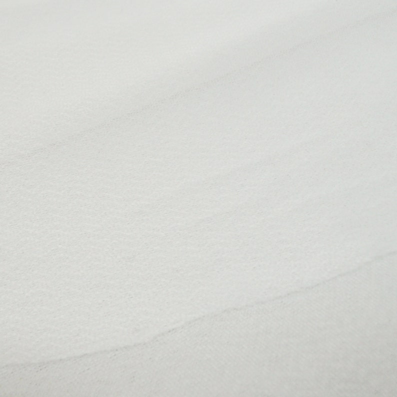May include: A close-up of a white, smooth, textured surface.