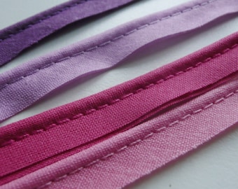2mm flanged insertion piping on a 9mm band, shades of Pink, Lilac, and Purple - sold by the metre (THE WALL)