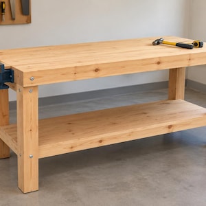 May include: A light-colored wooden workbench featuring a sturdy rectangular top, four thick legs, and a lower storage shelf. A blue metal vise is attached to the left side, while a hammer and a yellow measuring tape rest on the right side.