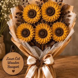 May include: A bouquet of five laser-cut wooden sunflowers with yellow petals and dark brown centers, accented by dark brown leaves and berries. The bouquet is wrapped in brown paper and white tissue, tied with a white ribbon and a small wooden butterfly.