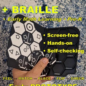 Puede incluir: Un juego táctil de aprendizaje de matemáticas en blanco y negro con fichas hexagonales que presentan formas geométricas y marcas en braille. El conjunto incluye un tablero plegable con ranuras hexagonales para colocar las fichas, diseñado para un aprendizaje práctico, sin pantallas y de autocomprobación, etiquetado como Solve&Flip.