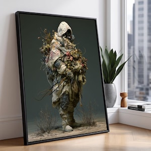 May include: A framed wall art print depicting a hooded figure draped in layered, tattered beige fabric and adorned with clusters of dried flowers and foliage. The figure wears dark, textured leg armor and stands against a muted, dark gray background.
