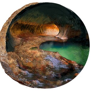 May include: A close-up view of a natural rock formation with a small pool of turquoise water at the bottom. The rock is a mix of brown, orange, and gray colors, with a smooth, rounded surface.