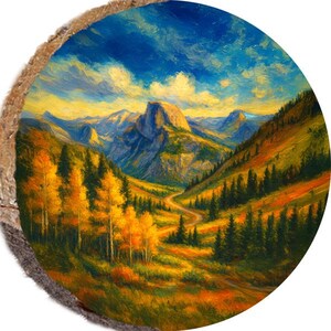 May include: A round wooden slice featuring a landscape painting of a mountain valley. The artwork depicts a winding road, autumn trees, and a mountain range under a blue and yellow sky. The painting is rich in color and detail.