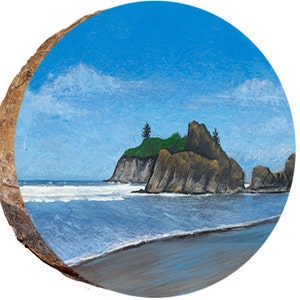 May include: A painting on a wooden round disc depicting a rocky island with green trees and a blue sky with white clouds. The island is in the middle of a blue ocean with white waves crashing on the shore.