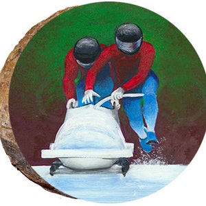 May include: Two people in red and blue racing suits are pushing a white bobsled on a snowy track. The bobsled is on a wooden surface with a green background.