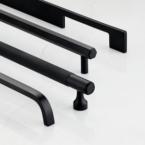 May include: Four black cabinet pulls in different styles. The pulls are arranged in a row from top to bottom. The top pull is a simple rectangular bar with rounded edges. The second pull is a rectangular bar with a more intricate design. The third pull is a round bar with a textured surface. The bottom pull is a curved bar with a rounded end.