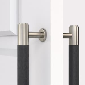 May include: Two brushed nickel door pulls with black leather wrapped handles. The pulls are mounted on a white door.