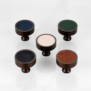 May include: A set of three ceramic mugs with a speckled, matte finish in cream, light grey, and dark grey. Each mug has a simple, minimalist design and a rounded handle.