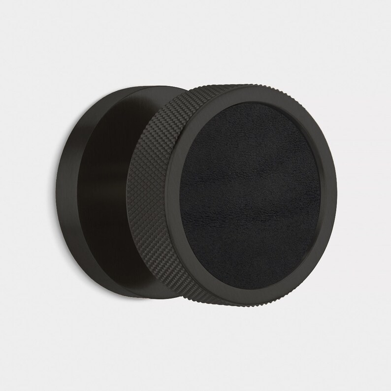 Peut inclure: Bouton de meuble noir circulaire avec une poign&eacute;e textur&eacute;e et un centre lisse et sombre. Le bouton est en mat&eacute;riau noir mat. Le design est moderne et minimaliste. Le bouton est de forme circulaire et con&ccedil;u pour une utilisation facile.