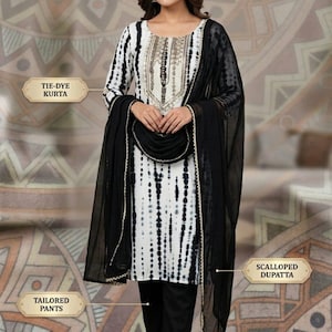 Puede incluir: Un conjunto completo de 3 piezas que consta de una kurta tie-dye blanca y negra con bordados dorados, pantalones negros entallados y una dupatta negra transparente con un borde festoneado.