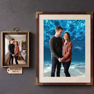 May include: A large rectangular wall frame with a dark wood finish and metallic corner accents containing a portrait of two people standing in front of an underwater shark scene. A smaller floating frame labelled REFERENCE PHOTO is displayed nearby.