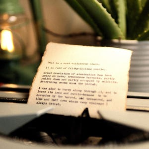 May include: A piece of off-white paper with burnt, deckled edges held in a typewriter. The text reads: Deal is a most villainous place. It is full of filthy-looking people. Great desolation of abomination has been going on here; tremendous barracks.