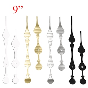 May include: Set of clock hands in white, gold, silver, and black. The hands are 9 inches long and have a decorative design.