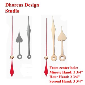 May include: Three clock hands, a red second hand, a gold minute hand, and a silver hour hand. The hands are shown against a white background. The text "From center hole: Minute Hand: 3 3/4", Hour Hand: 2 3/4", Second Hand: 3 3/4" is written below the hands.