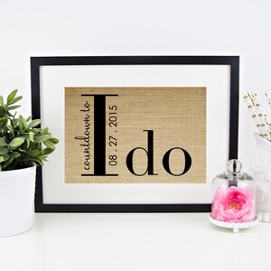 May include: A framed burlap print with the text "countdown to I do 08.27.2015" in black lettering.