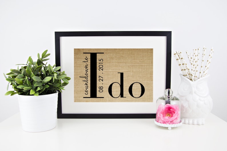 May include: A framed burlap print with the text "countdown to I do 08.27.2015" in black lettering.
