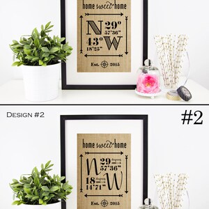 May include: Two framed prints with a burlap background and black text. The text reads "home sweet home" and includes coordinates with degrees, minutes, and seconds. The prints are labeled "Design #1" and "Design #2".