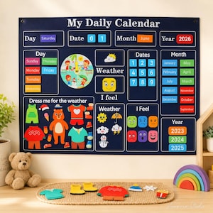 May include: A dark blue wall-mounted daily calendar with white text and colorful felt pieces. It features sections for day, date, month, year, weather, and feelings, plus a dress-up bear area with various clothing items and accessories.