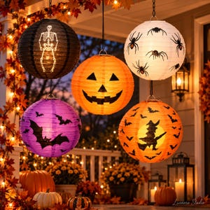 May include: Five spherical paper lanterns hanging outdoors. One black with a white skeleton, one orange with a jack-o'-lantern face, one white with black spiders, one purple with black bats, and one orange with a black witch silhouette and bats.