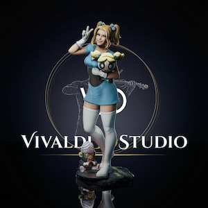 May include: A collectible figurine of a blonde character in a blue dress and white thigh-high boots, holding a small doll with blonde pigtails. A small green monkey-like creature sits at the base. The text VIVALDI STUDIO is visible behind.