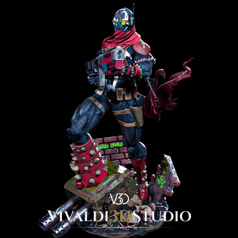 Peut inclure: Une figurine de collection d&eacute;taill&eacute;e repr&eacute;sentant un personnage masqu&eacute; portant une &eacute;charpe rouge, une armure noire &agrave; pointes et tenant une grande arme &agrave; feu. La figurine repose sur un socle avec un mur de briques, des d&eacute;bris et le texte VIVALDI 3D STUDIO.