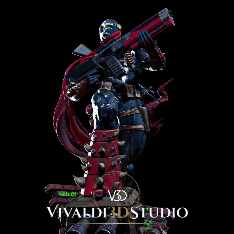 Peut inclure: Une figurine d&eacute;taill&eacute;e d'un personnage masqu&eacute; portant une combinaison noire avec des accents rouges, des pointes sur le bas des jambes et une cape rouge flottante. Le personnage tient un grand fusil rouge et noir. La base porte le texte VIVALDI 3D STUDIO.