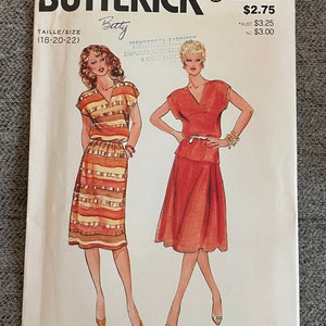 Può includere: Un modello di cucito vintage per un abito con scollo a V e gonna. Il modello è di Butterick e porta il numero 4268. Il modello è per le taglie 18-20-22. Il modello è per un abito con una gonna che è o a trapezio o dritta. Il modello è per un abito che è o corto o lungo. Il modello è per un abito che è o casual o formale. Il modello è per un abito che è o per il giorno o per la sera. Il modello è per un abito che è o per il lavoro o per il tempo libero. Il modello è per un abito che è o per l'ufficio o per una festa. Il modello è per un abito che è o per un appuntamento o per un matrimonio. Il modello è per un abito che è o per un'occasione speciale o per l'uso quotidiano.