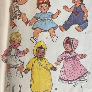 May include: A vintage sewing pattern for making doll clothes. The pattern includes instructions for making a variety of outfits, including a dress, a jumpsuit, a nightgown, and a hooded jacket. The pattern is illustrated with drawings of dolls wearing the different outfits.