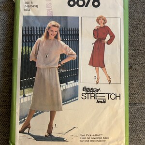 May include: Simplicity sewing pattern number 8678 for a dress with a skirt and a top. The pattern is for sizes 14, 16, and 18. The pattern is for stretch knit fabric. The pattern costs £1.35.
