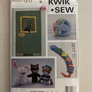 May include: A sewing pattern for making a variety of crafts, including a puppet theater, a ball, a snake, and three puppets. The pattern is from Kwik-Sew Pattern Co., Inc. and is number 1217.