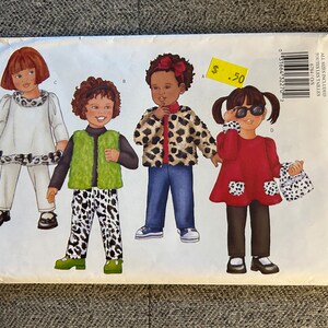 May include: Butterick sewing pattern 6784 for children's clothing. The pattern features illustrations of four different outfits, including a leopard print jacket, a red dress, and a white outfit with leopard trim. The price tag shows £0.50.