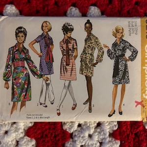May include: Simplicity sewing pattern number 9219 for a mini-length dress with a collar and long sleeves. The pattern includes five different views of the dress, each with a different print. The pattern is for size 10mp, bust 32 1/2, and is for Miss Petite.