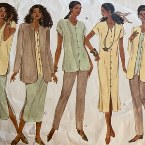 May include: A sewing pattern featuring five different clothing designs for women. The designs include a long-sleeved jacket, a long-sleeved blouse, a short-sleeved blouse, a long dress, and a pair of trousers. The pattern is printed on a white background with black text and illustrations.