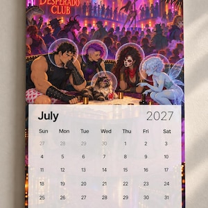 May include: A wall calendar for July 2027 featuring a fantasy illustration of a nightclub scene titled The Desperado Club. The artwork depicts four diverse characters and a cat wearing bubble helmets, set against a vibrant purple and orange background.