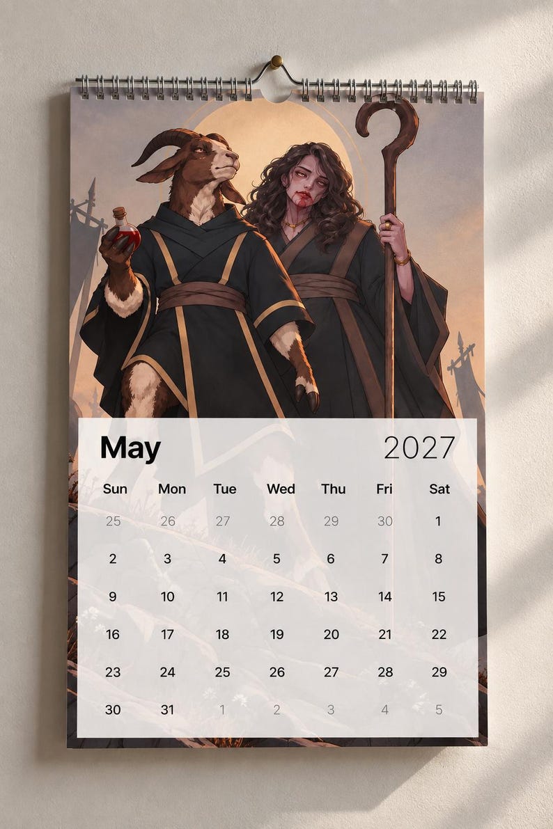 May include: A wall calendar for May 2027 featuring an illustration of a goat-headed figure in a black robe holding a red potion and a person with long dark hair holding a wooden staff, both set against a golden circular background.