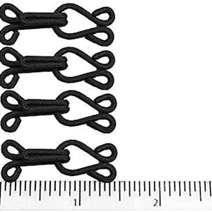 May include: Four black elastic loop and hook closures, each measuring approximately 1.5 inches in length. The closures are shown next to a ruler with inch markings.