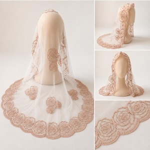 May include: A sheer, light-colored veil featuring intricate, copper-toned floral embroidery along the scalloped edges and scattered across the fabric. The design includes detailed rose-shaped motifs with small, centered embellishments.