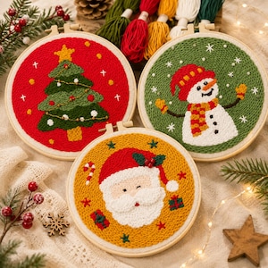 May include: Three circular embroidery hoops featuring punch needle designs: a green Christmas tree on a red background, a white snowman with a red hat on a green background, and a Santa Claus face on a yellow background with small gift icons.