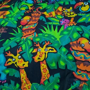 May include: A colourful fabric with a jungle-themed design. The pattern showcases cartoon giraffes, toucans, and other animals set amongst dense green foliage. The artwork uses bright colours such as orange, yellow, and blue against a black backdrop.