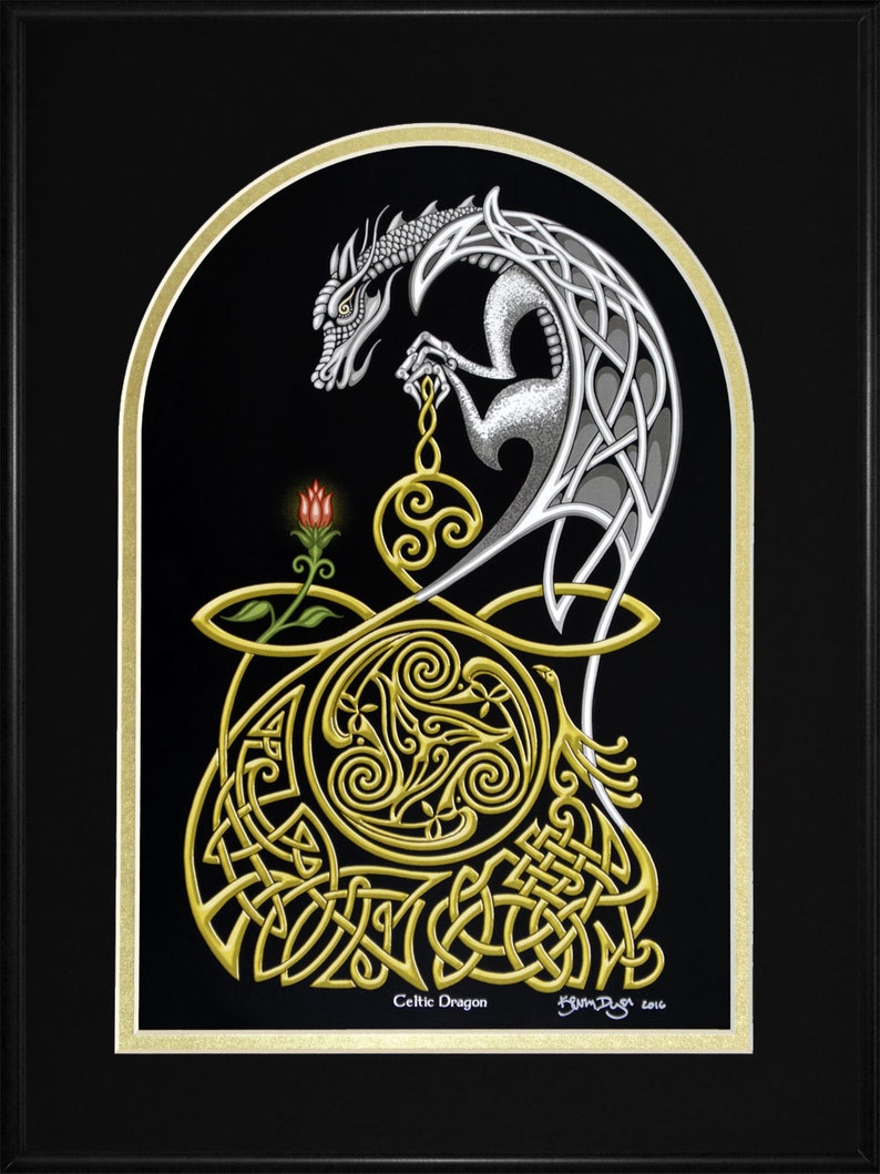 May include: A silver Celtic dragon with intricate knotwork design, holding a golden orb with a triple spiral motif. The dragon is set against a black background with a gold border.
