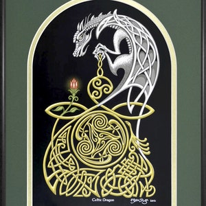 May include: A white Celtic dragon with gold accents is curled around a gold Celtic knot design. The dragon is holding a gold orb with a red flower below it. The image is framed in black and green.