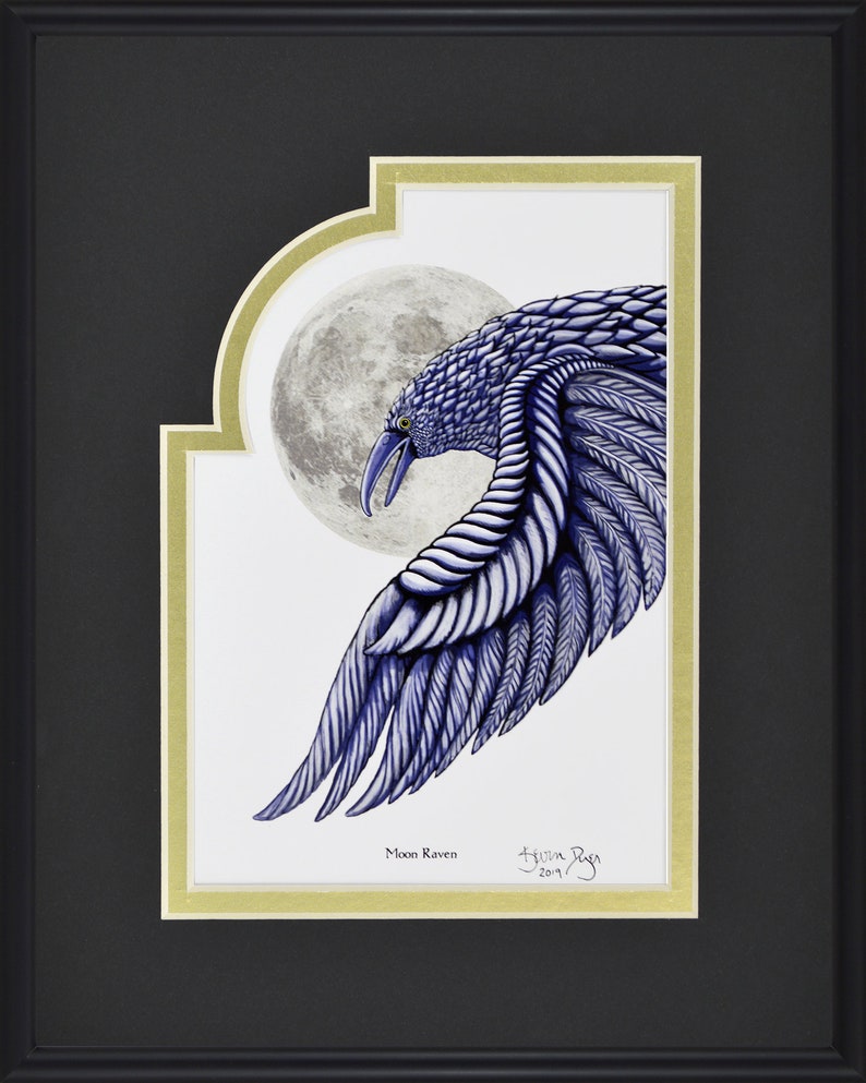 May include: Framed artwork featuring a stylized blue raven with a full moon backdrop. The raven's wing is detailed with textured feathers. The artwork is titled "Moon Raven" and signed by the artist. The frame is black with a gold inner border.
