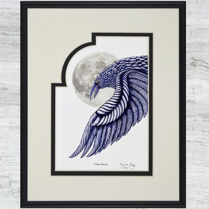 May include: Framed artwork featuring a detailed blue pen and ink drawing of a raven with a wing outstretched, set against a full moon. The artwork is titled "Moon Raven" and is signed by the artist. The piece is framed in a black frame.