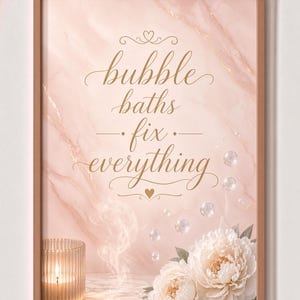 May include: A framed wall art print featuring a light pink marble background with the gold cursive text bubble baths fix everything. The design includes a lit candle in a ribbed glass holder, floating bubbles, and two white peony flowers.