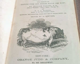 May include: An open book titled "The Hog" with text and an illustration of a pig. The book's cover features the title, author's names, and publisher's information. The illustration is a detailed engraving of a pig.